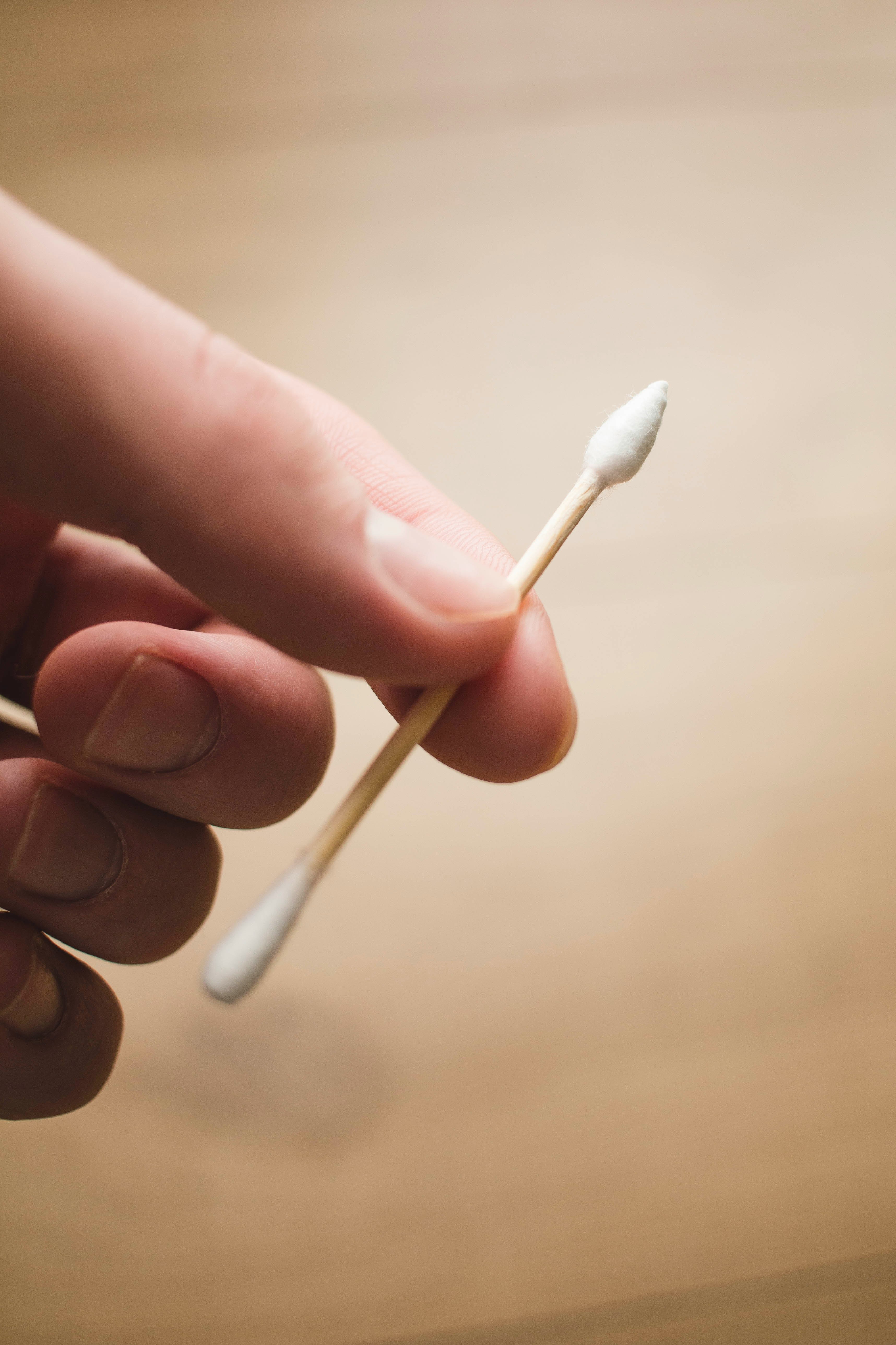 person holding white cotton buds